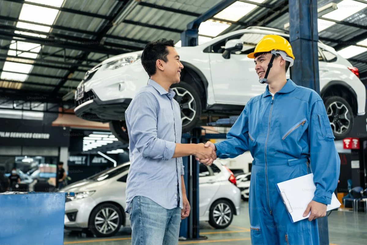 Prime AutoBase technician with a customer